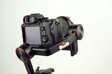 Fototapeta premium photographic camera in a steadicam on a table with a white background
