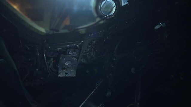 Interior of RAF Canberra Bomber showing Side Control Panels and Intermittent Lights in the Background. Close Up.
