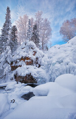 Aerial view of frozen river Pescherka near waterfall in winter. Siberia, Russia
