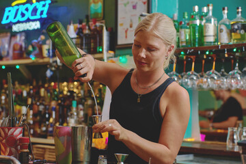 Female barman preparing drinks. cocktail bar Drinks at the bar. Fresh and cold drinks in a bar. Watermelon drink, jamiaca drink, margarita, micheladas.