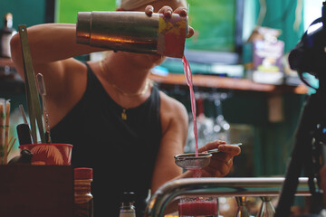 Female barman preparing drinks. cocktail bar Drinks at the bar. Fresh and cold drinks in a bar. Watermelon drink, jamiaca drink, margarita, micheladas.