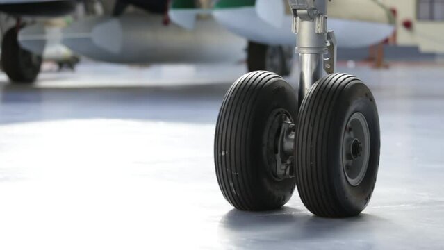 Tires on the Wheels of an Old Fighter Jet at Hangar. Closeup. 