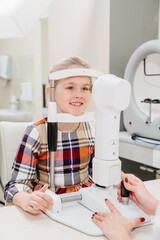 ophthalmologist examines the girl on a corneo topographer. modern clinic.