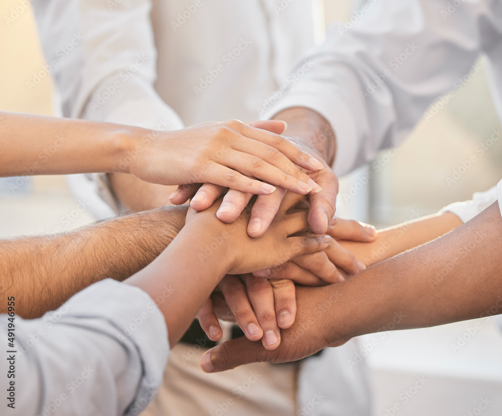 Aufkleber on three. cropped shot of an unrecognizable group of businesspeople huddled together in the office a