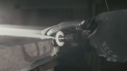 Forge. Smithy. Glass cutting and processing for fireplace doors. Circular glass cutter. Worker cut glass with glass cutting diamond. Polish an angle grinder with an abrasive circular disk nozzle.