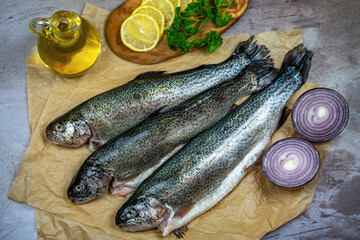 Three raw trout ready to be cooked.