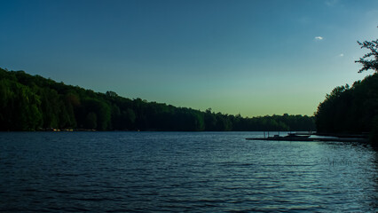 People hanging out on wooden deck nearby lake in Canada