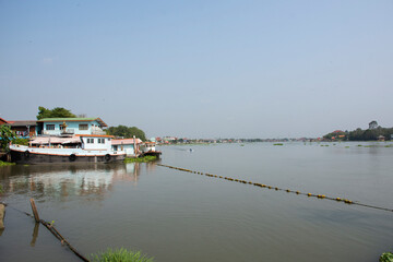 Life lifestyle of thai people at chaopraya riverside with boat and ship in fishing village for traveler travel visit at Ing Nam Sam Khok waterfront market at Pathumthani city in Pathum Thani, Thailand