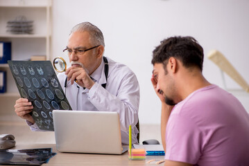 Young male patient visiting old male doctor radiologist