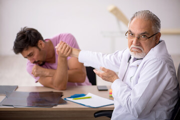 Young male patient visiting old male doctor