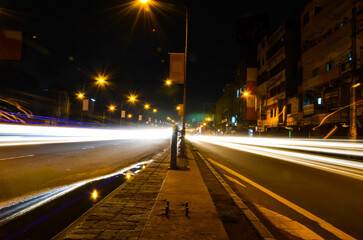 Long exposure of traffic lights and vehicles in the city. Motion blurred landscape of night scene in the city with motion in lights of traffic and city lights.