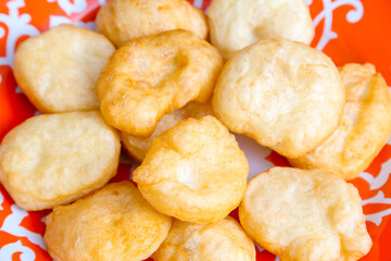 National Kazakh pastries baursaks in a plate on a wooden background