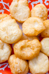 National Kazakh pastries baursaks in a plate on a wooden background
