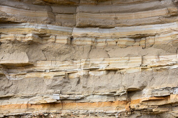 many layers of rock on a rocky wall