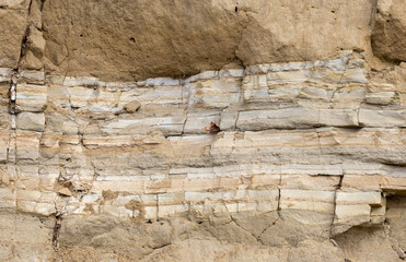 a rocky wall with many different layers of rock