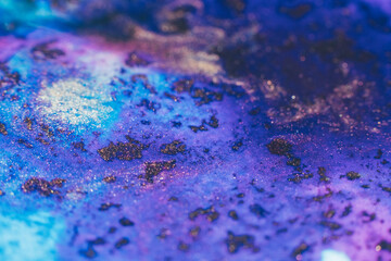 Mixed paints art. Abstract design background. Purple blue glitter ink blend
