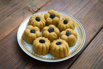 Traditional oriental sweet dessert zhent with raisins in a plate on a wooden background 
