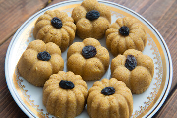 Traditional oriental sweet dessert zhent with raisins in a plate on a wooden background 
