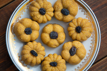 Traditional oriental sweet dessert zhent with raisins in a plate on a wooden background 
