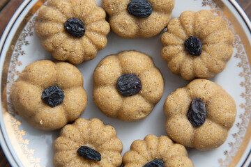 Traditional oriental sweet dessert zhent with raisins in a plate on a wooden background 