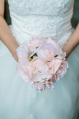 Obraz na płótnie Canvas Close up of a bride holding a flower wedding bouquet