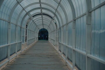 Almaty, Kazakhstan - 05.20.2021 : Tunnel passage to the airport with a glass arch.