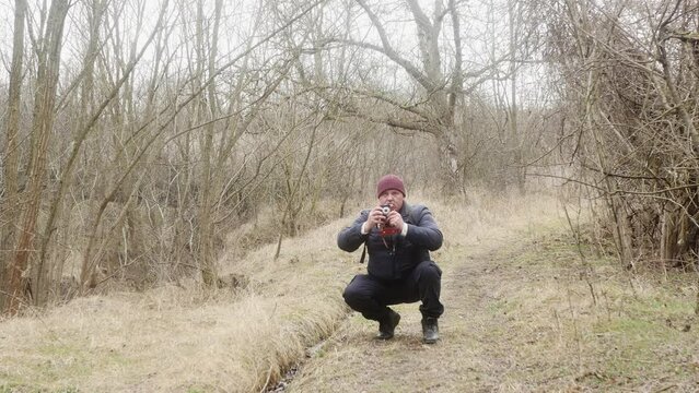 travel photographer photographing forest on retro film camera front view