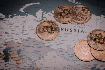 Pile of bitcoins on russia in world map. concept of crypto currency and economic crisis.