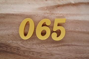 Golden Arabic numerals on a real brown and white wooden floor number 070
