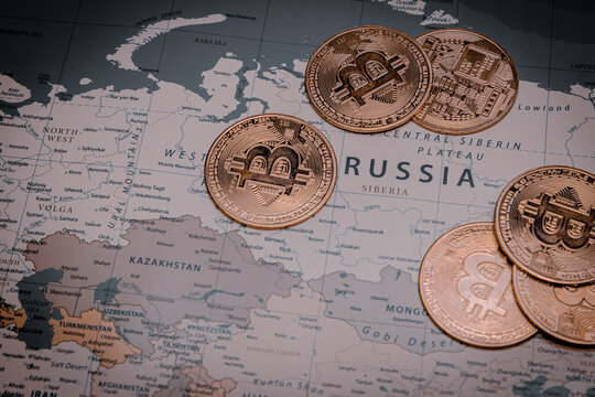 Pile of bitcoins on russia in world map. concept of crypto currency and economic crisis.