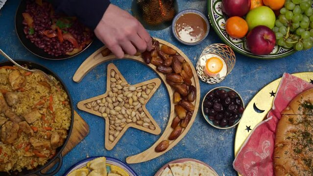 Ramadan iftar Eid. Muslim family has dinner at home. Table with traditional food. Eid al-Fitr celebrations
