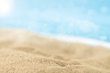 Fototapeta na wymiar Sand Close-up with blurred sea sky background, summer day