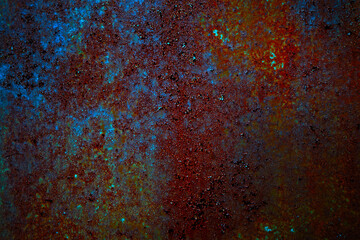 Rusty metal texture. Dark red orange blue abstract background. Cracked peeling paint. Old painted iron surface. Background for design.