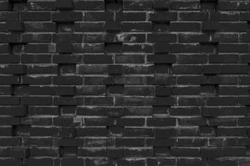 The black wall texture uses a lot of bricks. or black brick wall with abstract pattern for decoration.