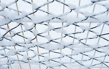 snow covered wire mesh winter background