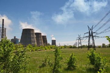 Fototapeta na wymiar Pavlodar, Kazakhstan - 05.29.2015 : Cooling towers and pipes of various compartments of a large thermal power plant