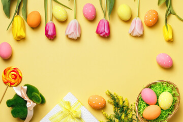 Easter composition on a yellow background. Tulips eggs rabbit gift. Frame with space for text and copy