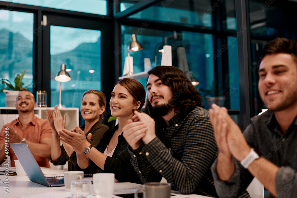 Poster what a great presentation. shot of a group of businesspeople applauding while sitting in the boardro