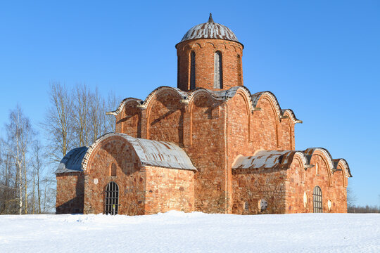 The medieval Church of the Transfiguration of the Savior on Kovalevo is close-up on a sunny March day. Surroundings of Veliky Novgorod, Russia