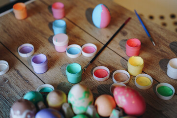 Fototapeta na wymiar handmade coloured eggs and acrylic paint. Easter flatlay