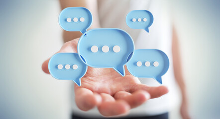 Businessman using digital speech bubbles talk icons. Minimal conversation or social media messages floating over user hand. 3D rendering
