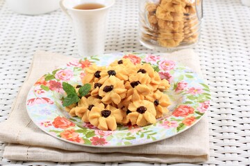 Kue Semprit, Indonesian Traditional Cookies Served to Celebrate Lebaran Idul Fitri Ied Mubarak. Made from Butter, Flour, Egg, with Flower Shape.