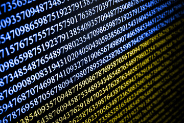 Numbers on computer screen. Macro photography with visible pixels. Binary code. Ukrainian flag color background. Ukraine national colors hackers texture. Cyber war background.