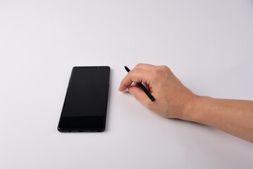 Hand and smartphone and black stylus for writing isolated on white background. 