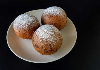 Lithuanian donuts on a plate against a dark background