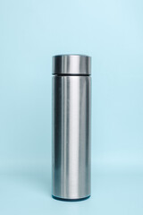 Stainless steel thermos for mock up isolated on a pastel blue background