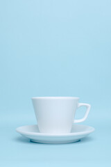 Plain white ceramic cup for mockup isolated on pastel blue background