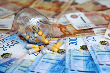 Pills on banknotes of the russian rubles. Medication in capsules, concept of pharmaceutical business, rise in price of medicines, healthcare in Russia