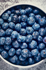Top down shot of fresh and tasty blueberries in bowl.