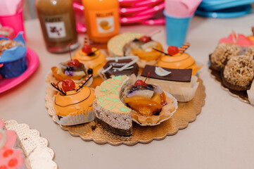 Sweet cakes at a wedding banquet. Catering, sweet festive buffet. Candy bar
